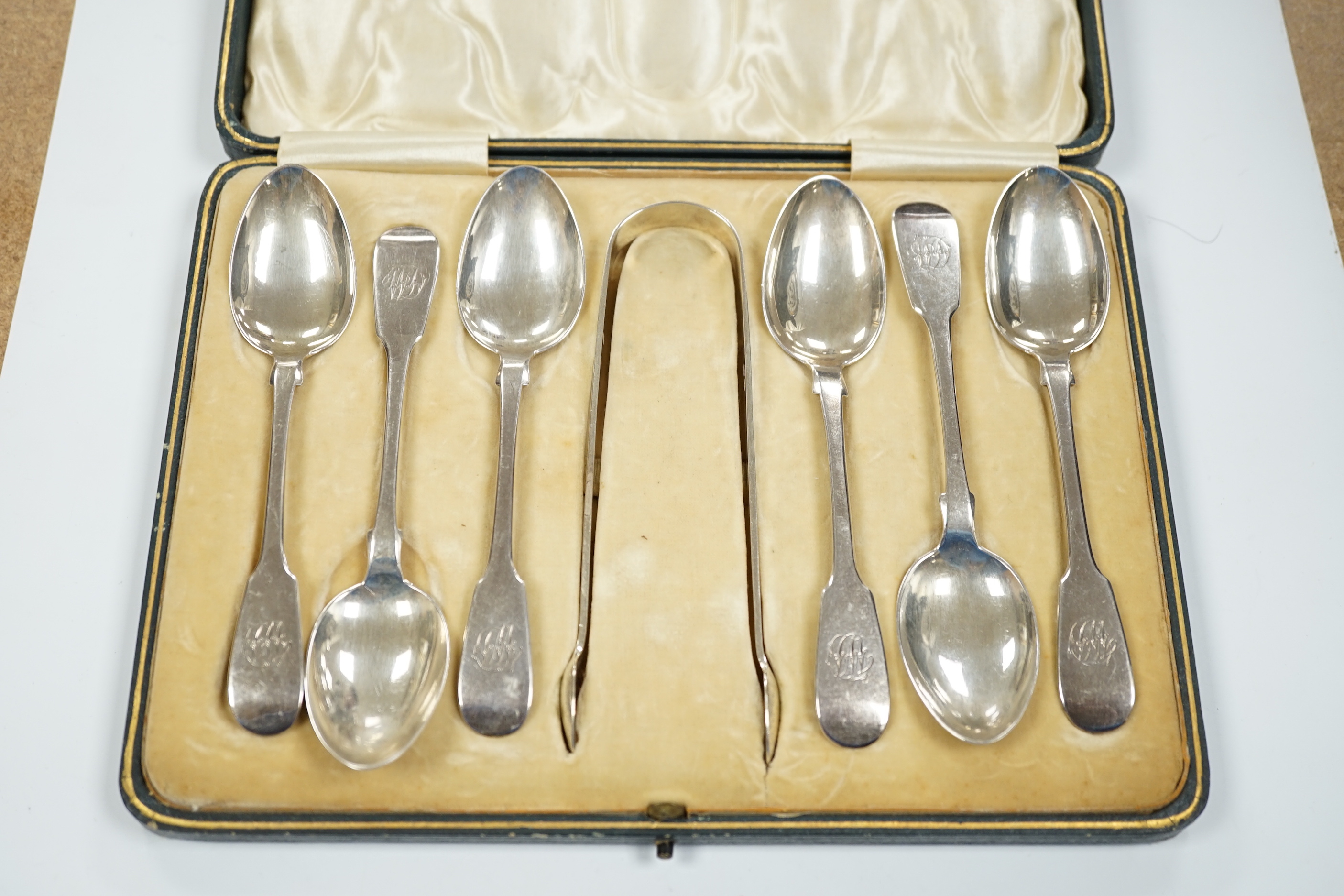 A set of six Victorian provincial silver fiddle pattern teaspoons, Reid & Sons, Newcastle, 1873 and a pair of associated silver sugar tongs, in associated case.